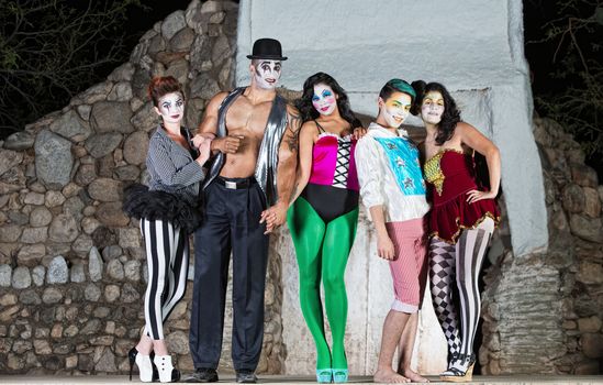 Group of comedia del arte clowns on stage