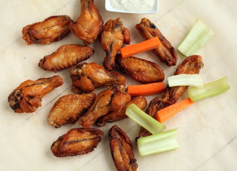 Chicken wings with sauce and vegetables