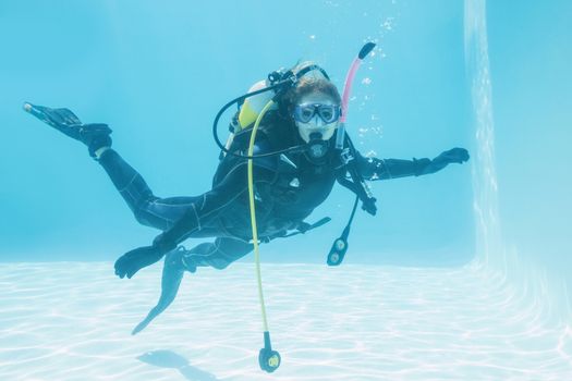 Woman on scuba training submerged in swimming pool