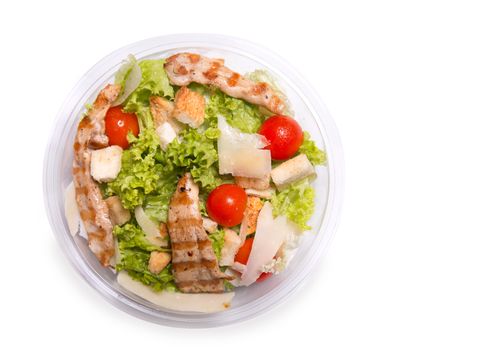 Caesar salad with grilled chicken meat, top view 
