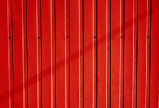 Scarlet corrugated metal fence as a background