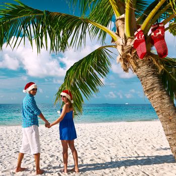 Couple in blue clothes on a beach at christmas