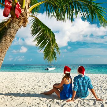 Couple in blue clothes on a beach at christmas