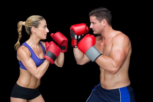Bodybuilding couple posing with boxing gloves