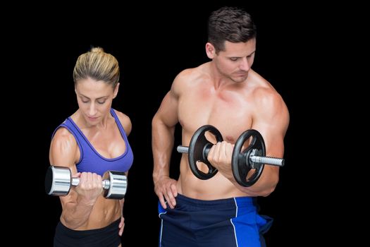 Crossfit couple posing with dumbbells 