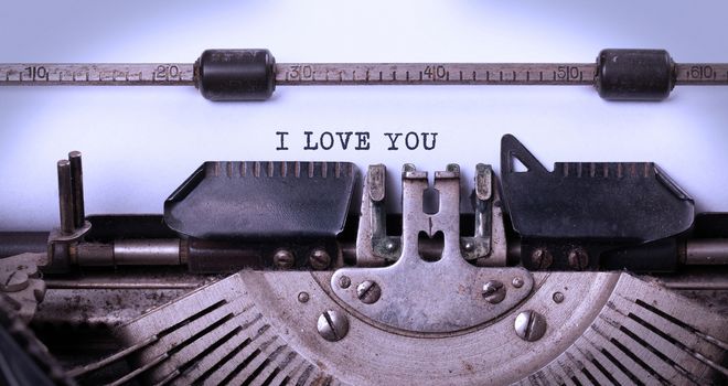 Close-up of a vintage typewriter, old and rusty, i love you