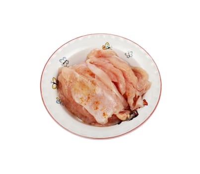 Thawed peppered pork meat in a plate isolated on white background