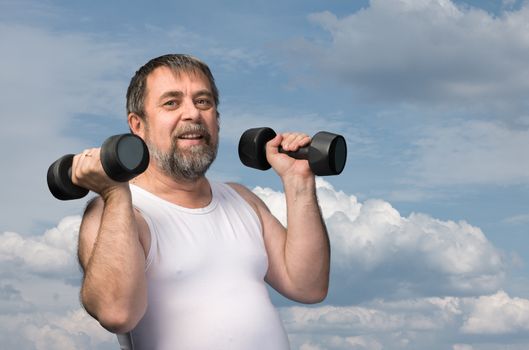 man exercising with dumbbells