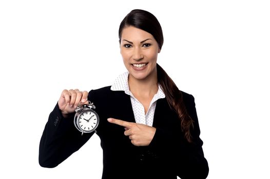 Pretty business woman holding alarm clock