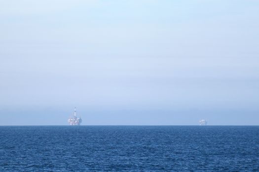 Two oil rigs in front of the Ventura coast.