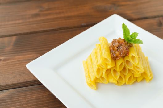 Penne Bolognese on wood table