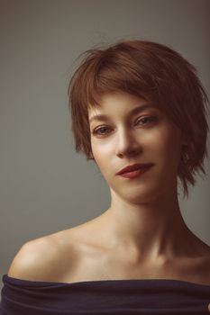 portrait of a young woman with short brown hair and brown glowing eyes
