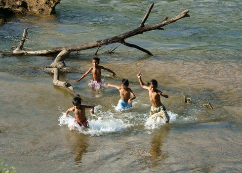 Asian children bath on Vietnamese river