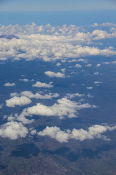 Soft clouds over view from airplane flying