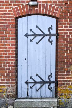 wooden door wih ornamental metal hinge
