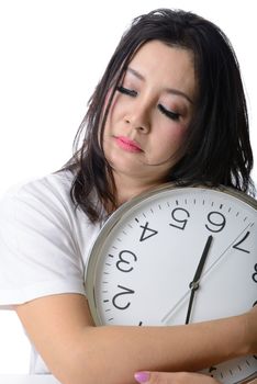 Sleepy asian woman hug the clock.