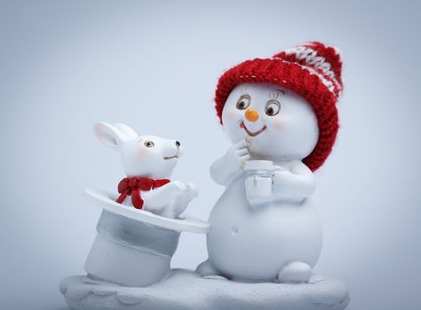 Cheerful snowman shows tricks