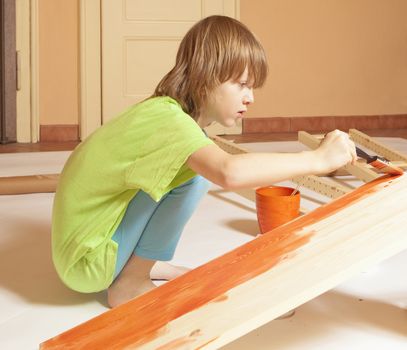 Boy with Blond Hair Painting a Board 