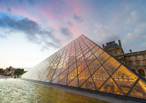 PARIS - JUNE 15 : Louvre museum at twilight in summer on June 15