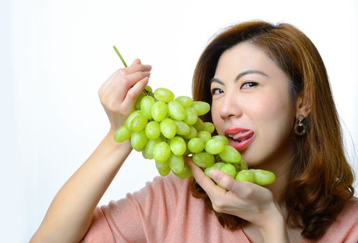 Beautiful asian woman with grape