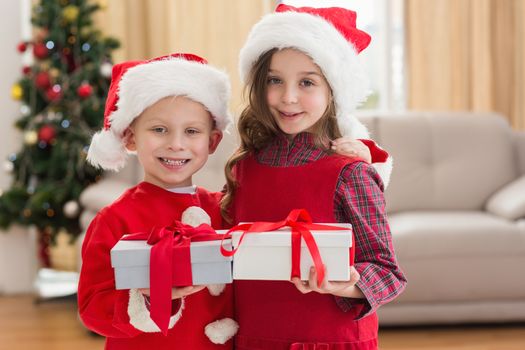 Festive little siblings holding gifts