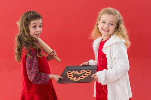 Festive little girls holding cookies