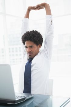 Businessman in shirt stretching his arms