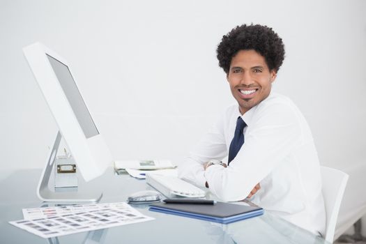 Smiling businessman sitting and looking at camera
