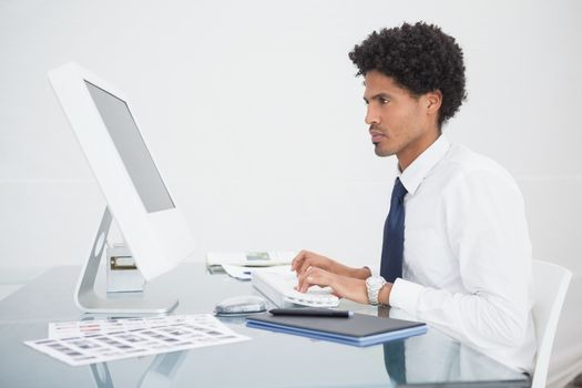 Focused businessman typing on keyboard 