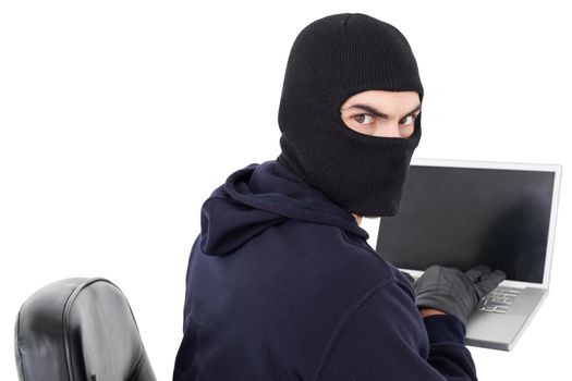 Hacker sitting and hacking laptop 
