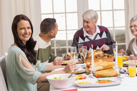 Smiling woman with her family during christmas dinner