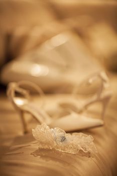 Bridal garter belt lingerie wedding shoe of bride on bed