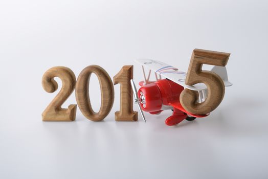 New year 2015 sign made by wooden number and toy airplane