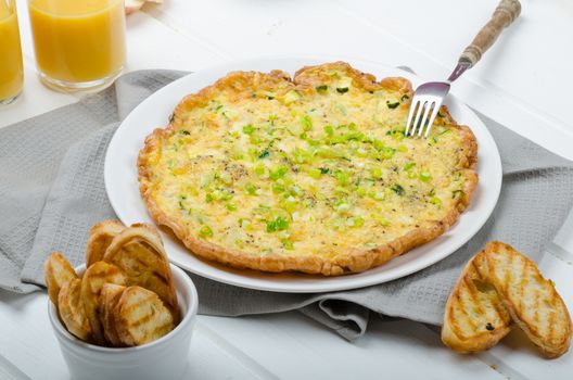 Omelette with zucchini and mozzarella cheese, scallions