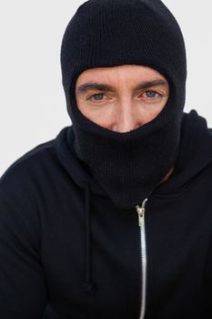 Portrait of a burglar with black jacket and balaclava