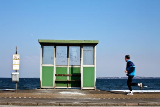 View of the danish east coast bus stop and man running