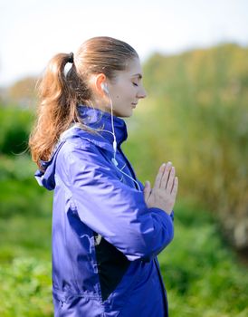 Young Beautiful Woman Meditate in the Park