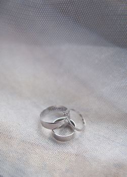 Platinum engagement and wedding ringson on fabric