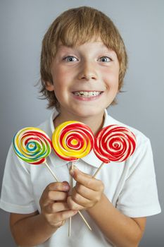 child boy eating lollipop