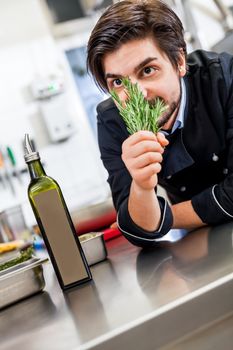 Chef checking the freshness of a bunch of herbs