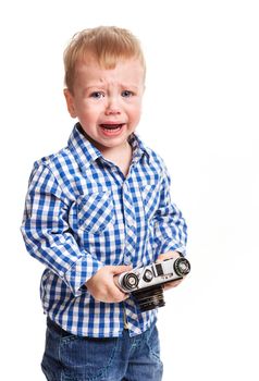 Toddler boy holding camera and crying