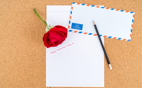 Cardboard, corkboard with note paper with pencil and rose beside for writing love letter, space for text