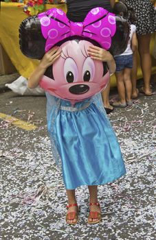 SAO PAULO, BRAZIL - JANUARY 31, 2015: An unidentified girl dressed like a princess with a Minie ballon in front her face participate in the annual Brazilian street carnival dancing and singing samba.