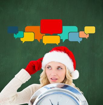 Composite image of happy festive blonde with clock