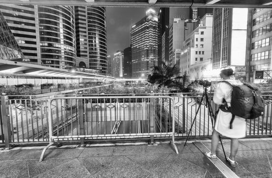 HONG KONG - APRIL 19, 2014: Unknown female photographer takes pi