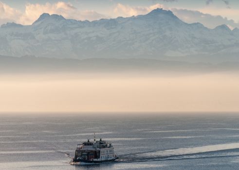 Ferry boat on a mountain lake with fog