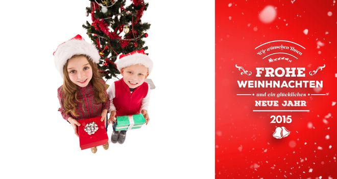 Composite image of festive little siblings smiling at camera holding gifts