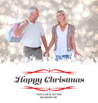 Composite image of happy couple with shopping bags