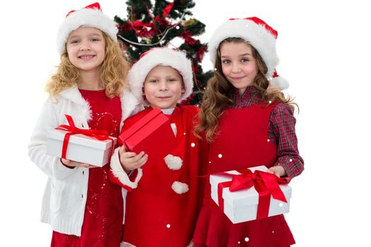Composite image of festive little siblings holding gifts