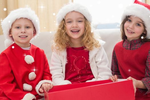 Composite image of festive little siblings smiling at camera